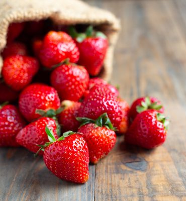 Fresh strawberries on wooden table.