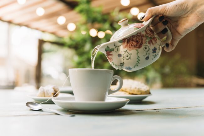 Hand serving tea